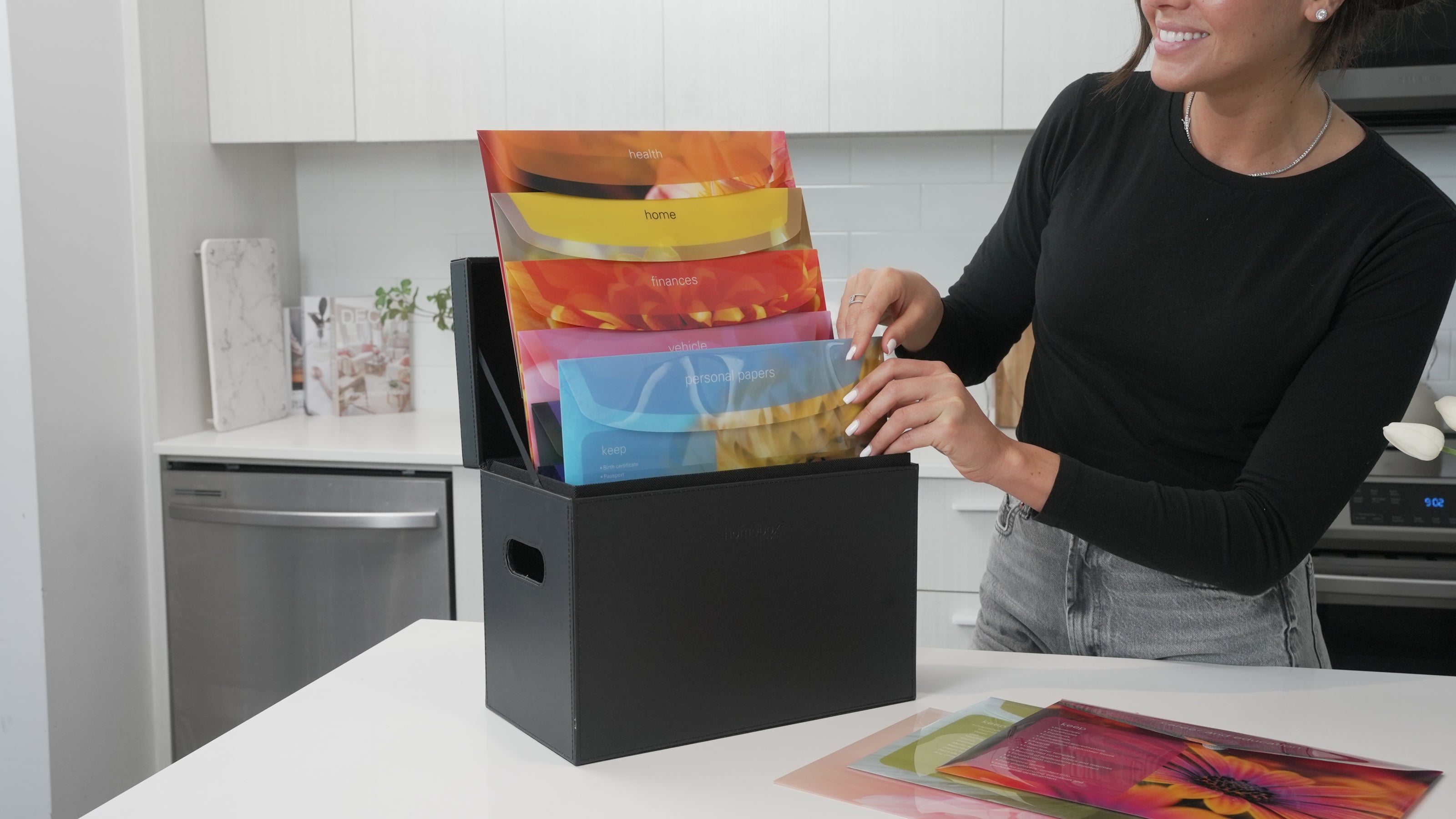 A lady showing how to organize files using the Homebox Filing System